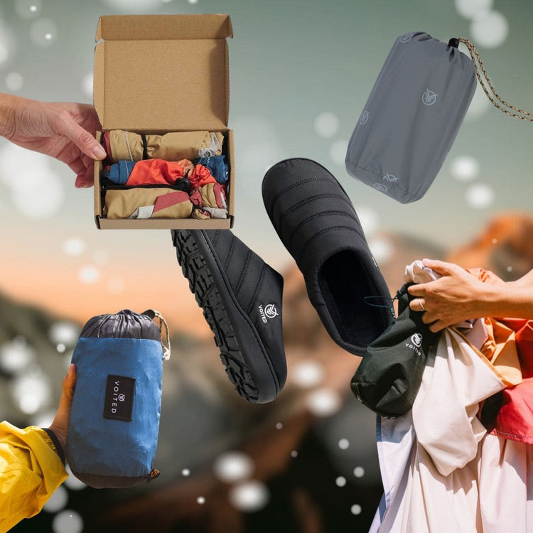 Collage of VOITED products against a blurred mountain backdrop: black slippers, liners in a gift box, the Tout Pack and the Sandfree Beach Sheet in their compact stuff sacks. 